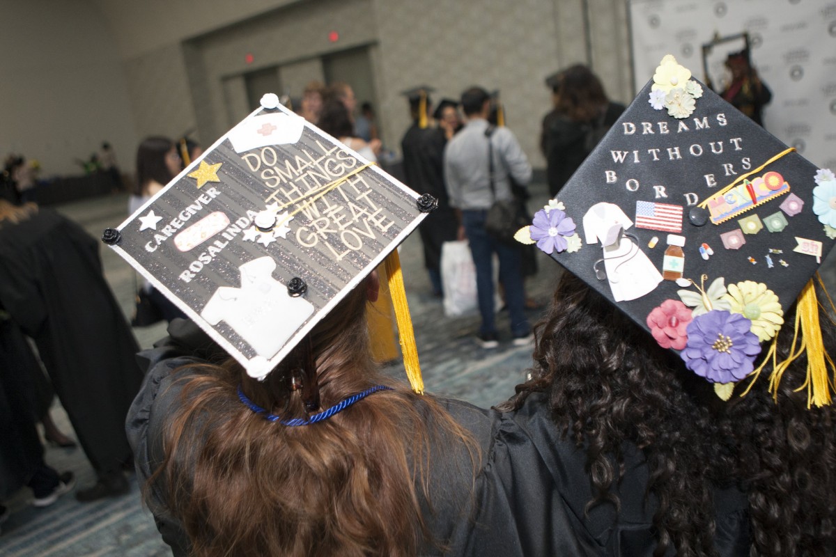 SDCE graduates decorate graduation caps with “Do Small Things with Great Love” and “Dreams Without Borders”