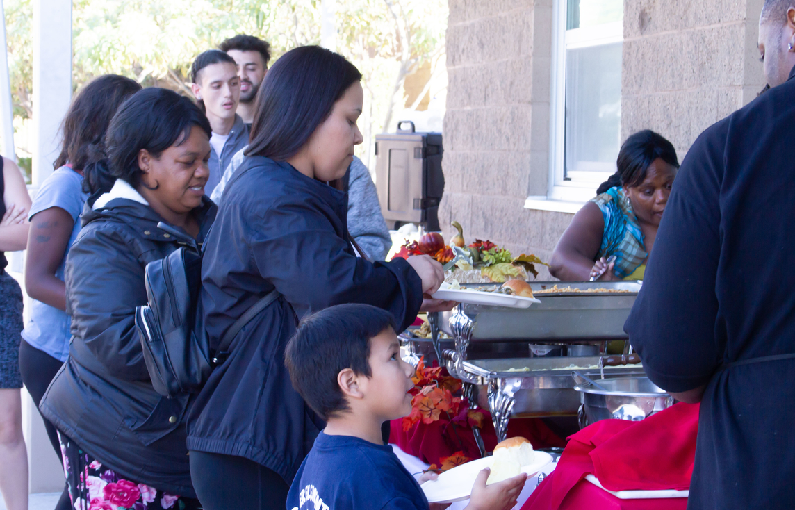 Congressman Scott Peters gifts San Diego Continuing Education students and their children a Thanksgiving meal.